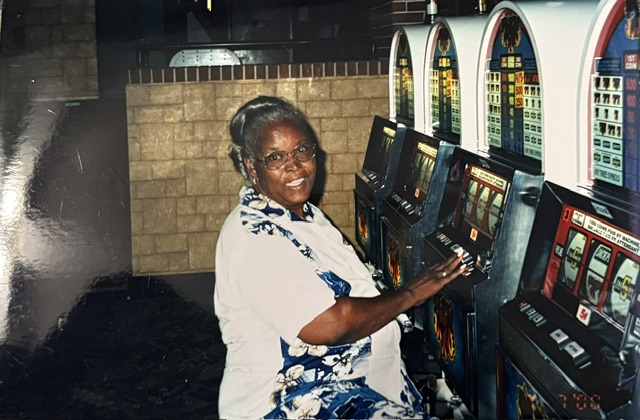Family member smiling beside slot machines